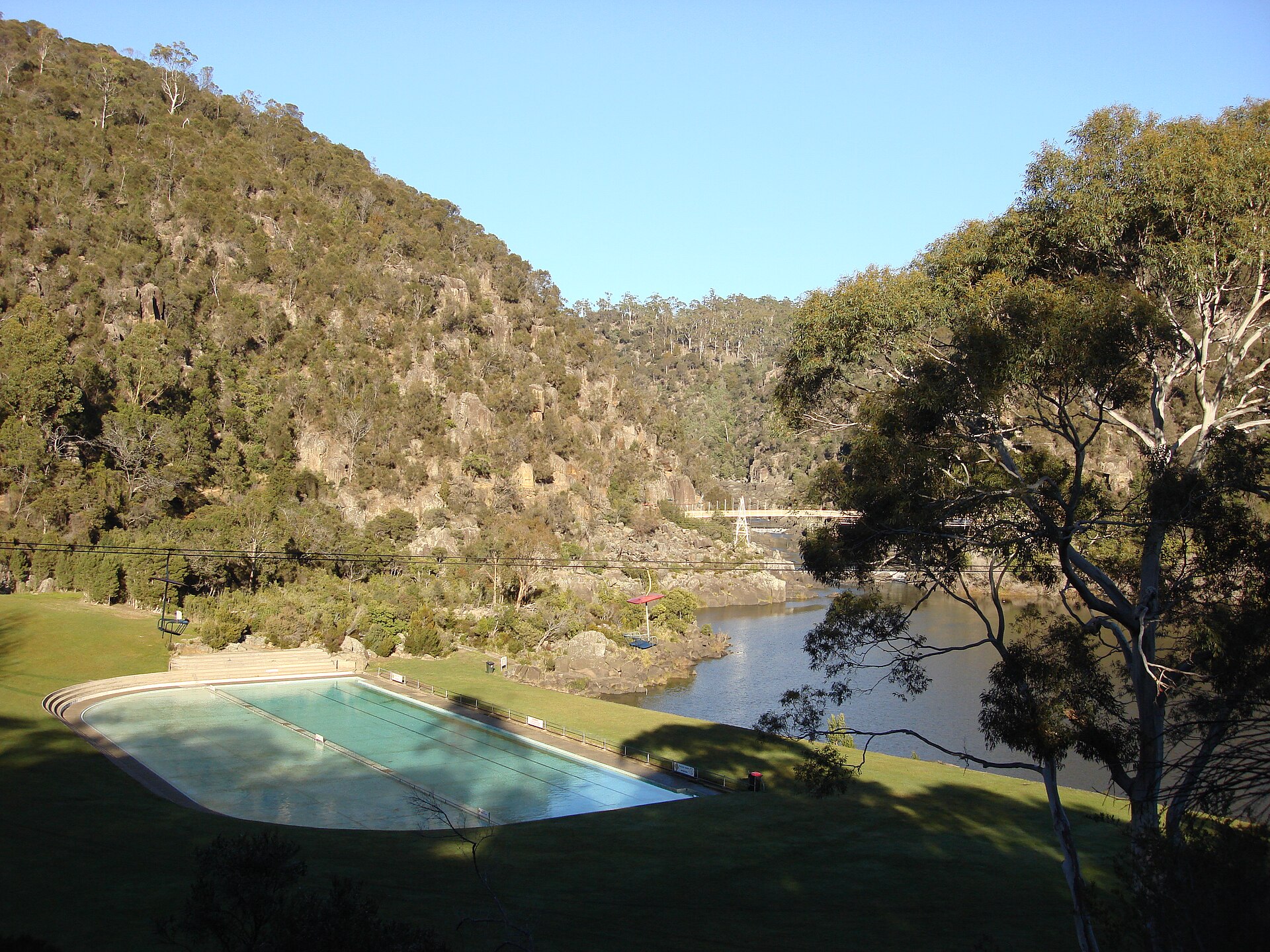 A swimming pool set into a steep gorge landscape in Launceston